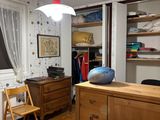 a bedroom with a bed, dresser, and a window