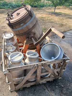 a wooden crate filled with pots and pans on the ground