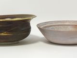 two bowls sitting next to each other on a white surface