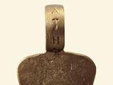 an image of a metal guitar pick with the letter a on it
