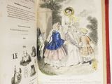 an open book with a picture of a woman and two children