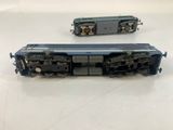 two trains that are sitting side by side on a table