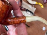 a person holding a pipe in their hand on a table