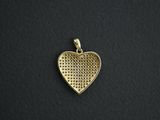a gold heart shaped pendant on a black background
