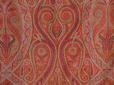 an image of a red and orange paisley design on a pink background
