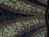 a close up of a piece of art with beads on it