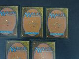 four decks of magic the gathering cards on a table