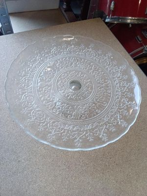 une plaque de verre posée sur une table, avec un tambour rouge en arrière-plan