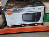 a box of microwaves on the shelf in the store