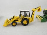 two toy construction vehicles that are next to each other