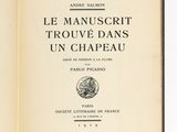 un livre ouvert posé sur une table à côté d'une table blanche