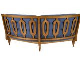 an image of a wooden bench with blue upholstered cushions