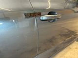 a close up of a car door handle with a sticker on it