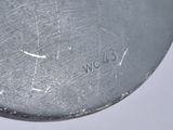 a close up of a metal object on a white surface
