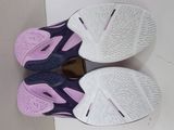 pair of purple and white tennis shoes on a white surface