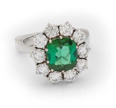 an emerald and diamond cluster ring