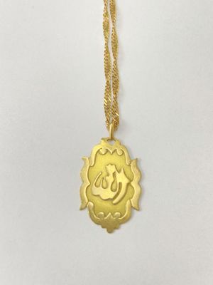a gold plated necklace with a smiling face on it