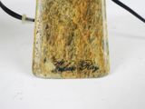 a close up of a lamp on a white surface