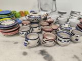 many plates and cups sitting on a table