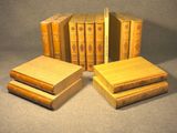 several books are stacked on top of each other on a table