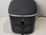 an image of a black and silver air fryer on a counter
