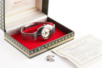 a box with a watch inside of it on a table