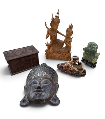 a group of statues and a box on a white surface