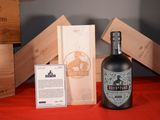 a bottle of wine sitting next to a box of wine