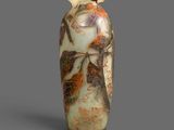 a vase with a design on it sitting on a table