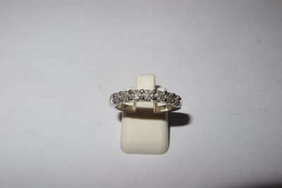 a close up of a diamond ring on a white surface