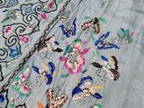 an image of a close up of a piece of clothing on a bed
