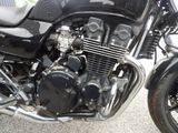 a close up of a motorcycle parked on the side of the road