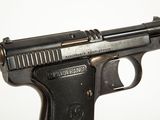 a gun that is sitting on a white surface