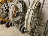 several different types of hoses are lined up against a wall