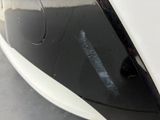 a close up of a black and white car with a sticker on it