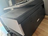 a black printer sitting on top of a wooden table