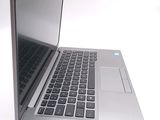 an open laptop computer sitting on top of a white surface