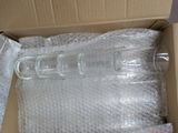 a plastic bottle in a box with bubble wrap around it