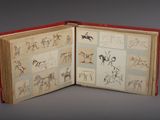 an open book with drawings of horses and people on it