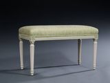 an upholstered bench with a green upholstered seat and legs