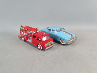 two toy cars sitting next to each other on a table