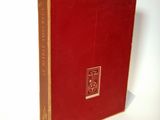 a red book that is sitting on a white surface