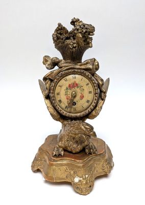 a gold clock with a crown on top of it