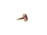 a close up of a gold ring with a purple stone