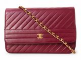 a close up of a red purse on a white background