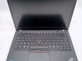 the laptop is open on a white surface with a black keyboard