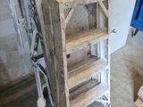 a wooden shelf with a ladder in the middle of a room