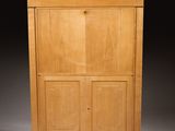 a wooden cabinet with two doors and a door on top of it