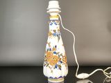 a white bottle with a blue and yellow design on it