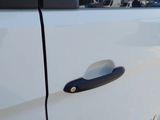 a close up of a white truck with a black handle